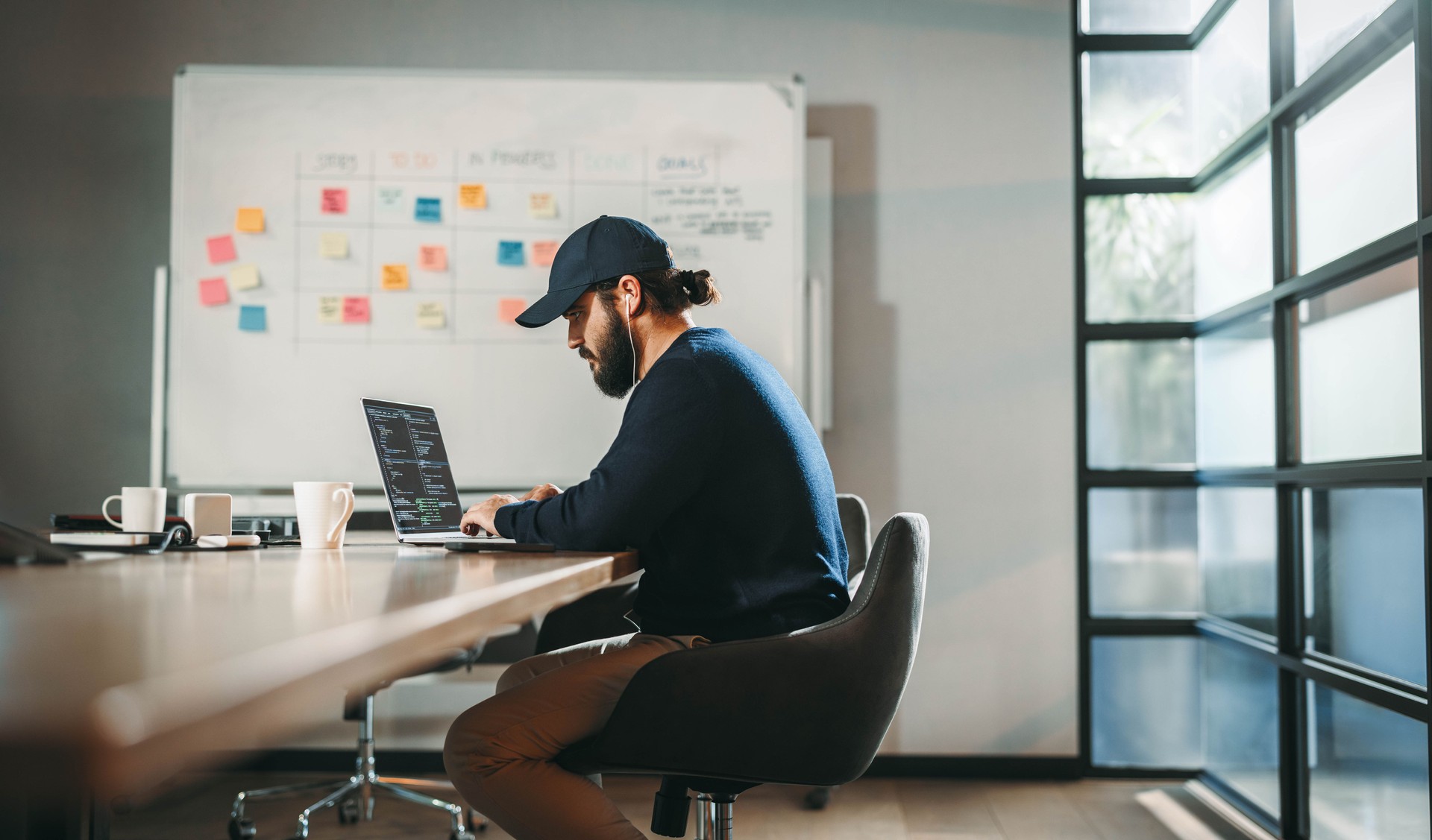 Young professional engaged in software development at a tech company's open office