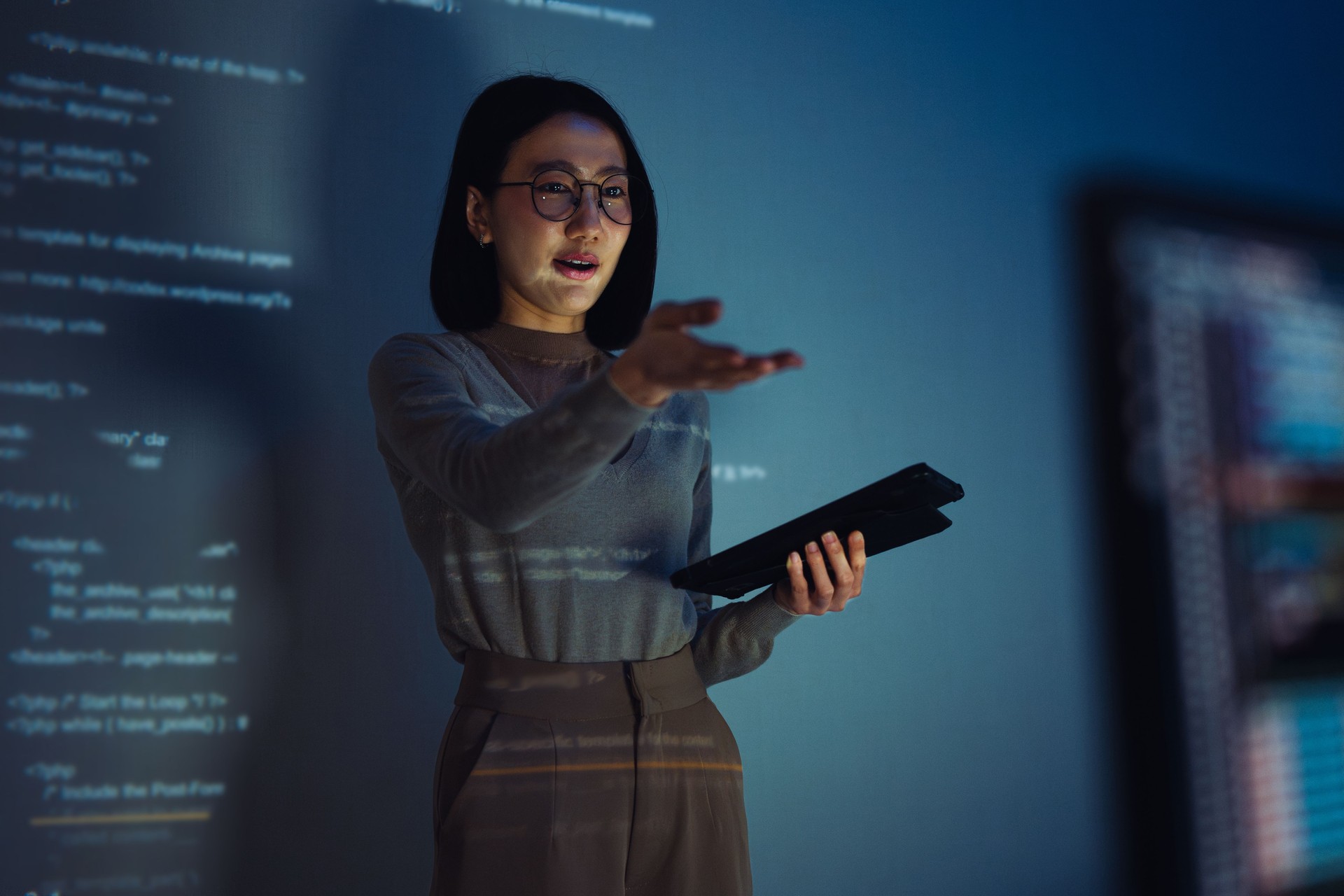 asian woman developer presentation about coding software data with devops team at night in office