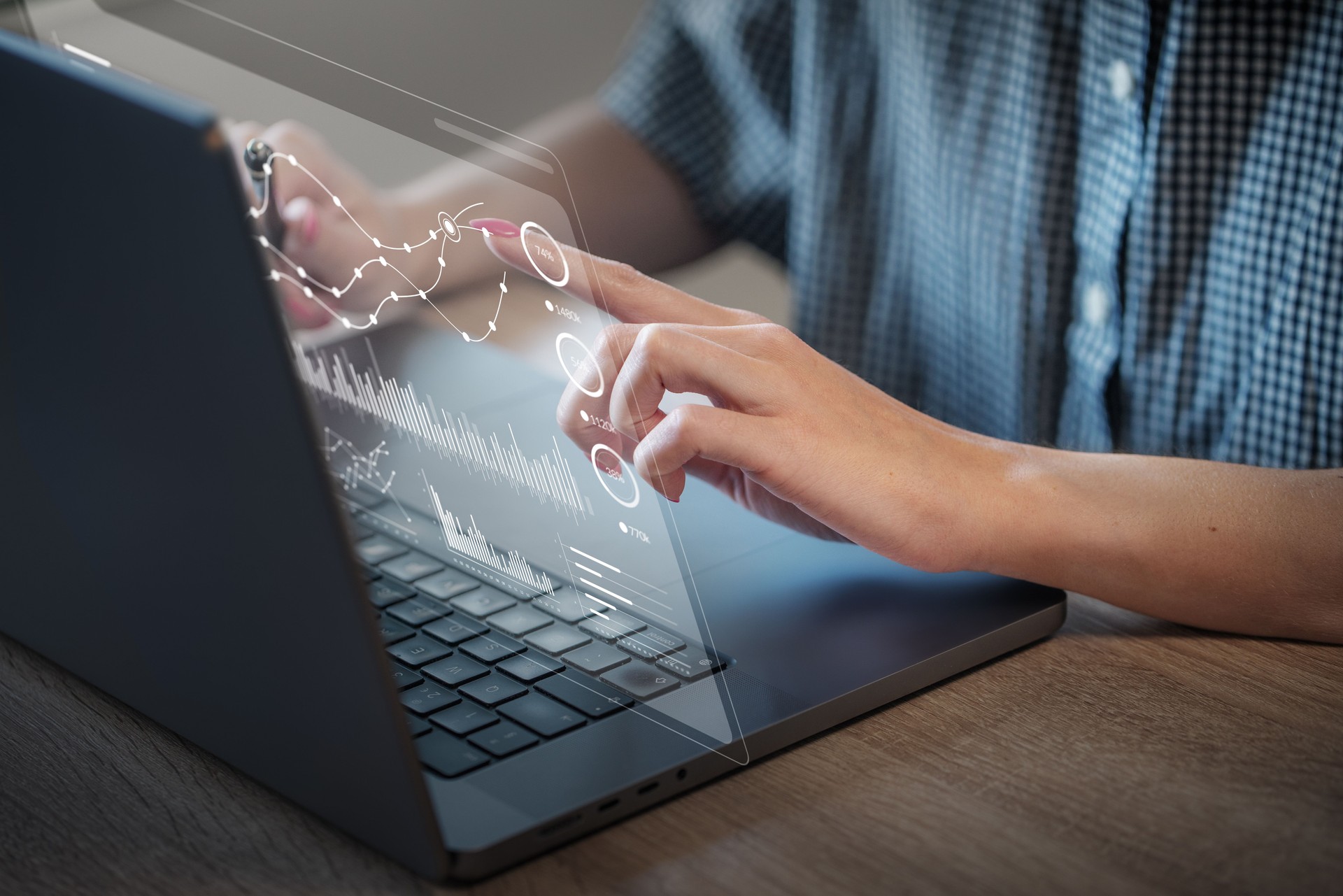 Woman works with a holographic financial data on interactive dashboard of the laptop